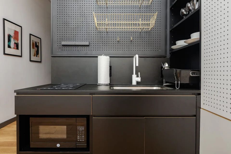 Prepare breakfast effortlessly with induction cooktop and deep sink.