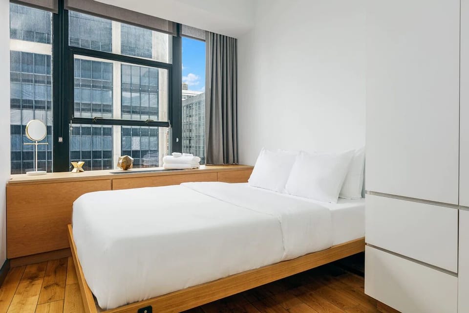 Wake up refreshed in crisp linens beside sunny city views.