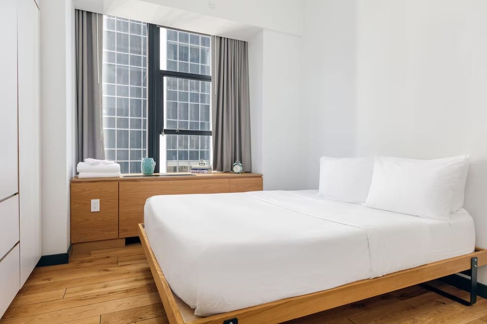 Settle into cloud-soft bedding with bright skyline views.