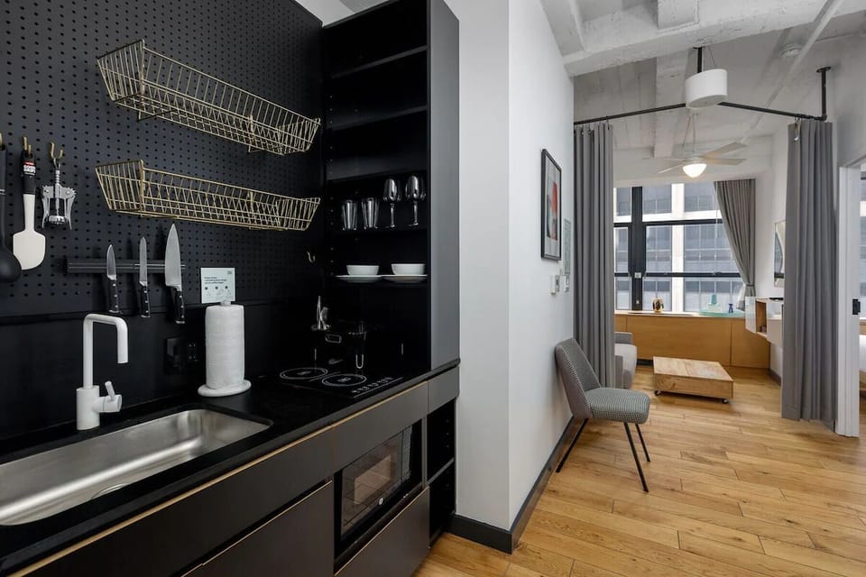 Cook with ease in the sleek kitchenette, fully stocked essentials.