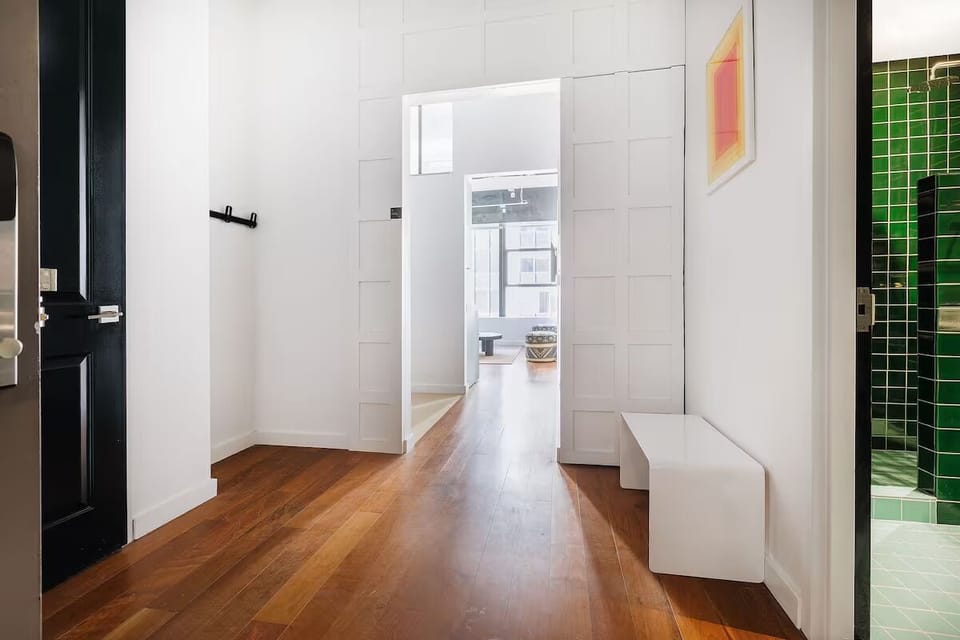 Step inside a bright, airy entry with warm wood floors.