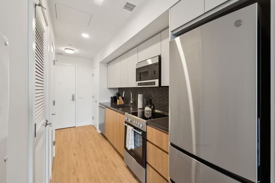 Prepare easy meals with full-size fridge and stainless appliances.