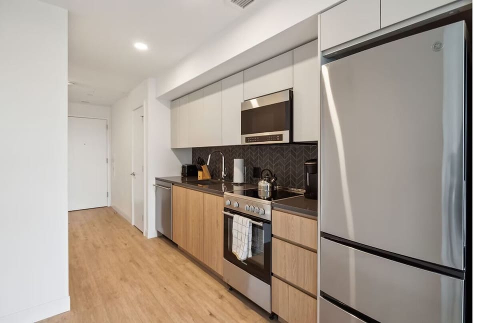 Cook with ease in the sleek kitchen with stainless appliances.
