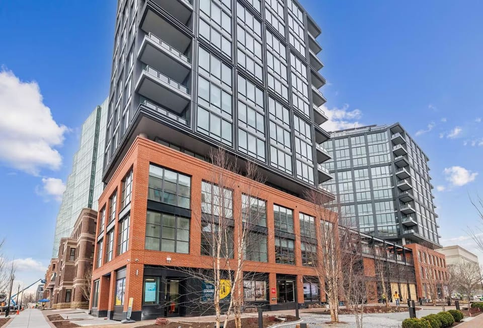Arrive to a sleek modern building in a vibrant district