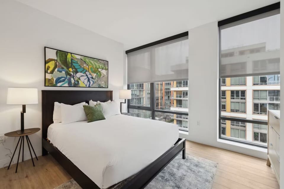 Sink into crisp linens and wake to sunlit city views.