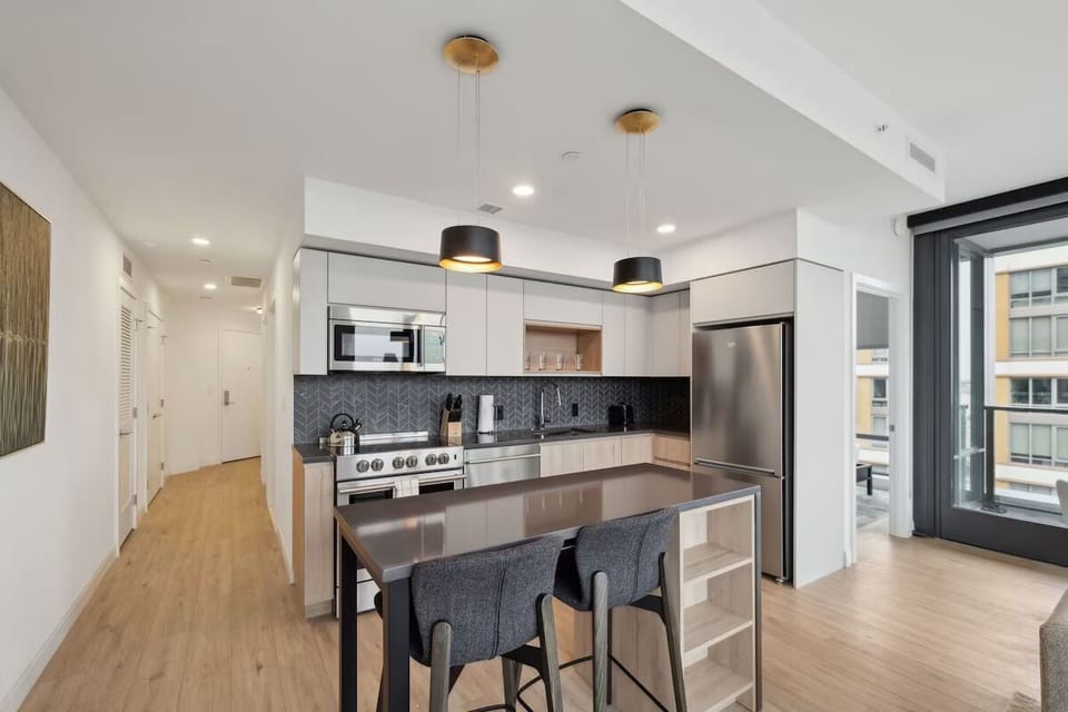 Cook with ease in a sleek kitchen with stainless appliances.