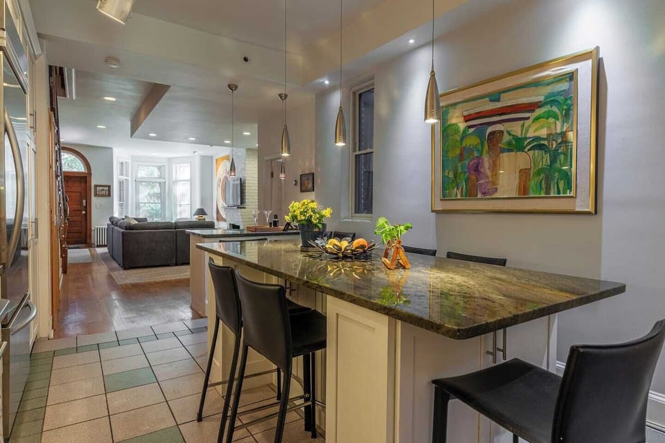 Granite table seats 8. Exceptionally well-stocked kitchen with service for 12. Large refrigerator and freezer with built-in ice maker. Dishwasher. Gas stove.  Service bar with sink. 