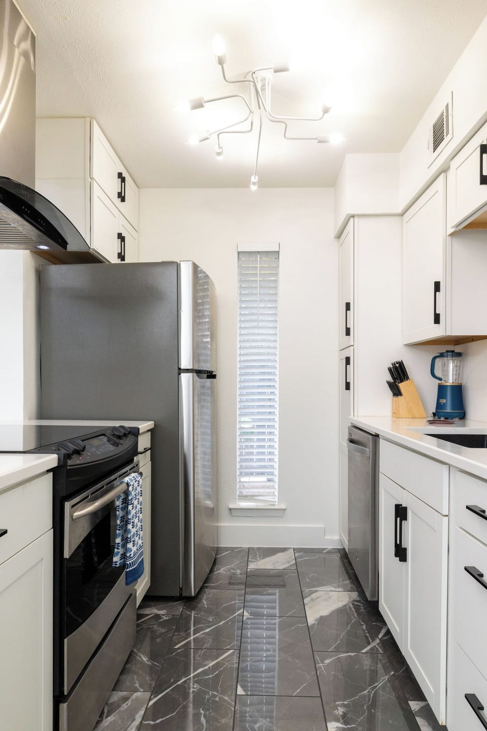 Modern kitchen w/ stainless steel appliances and stylish countertops & cabinetry