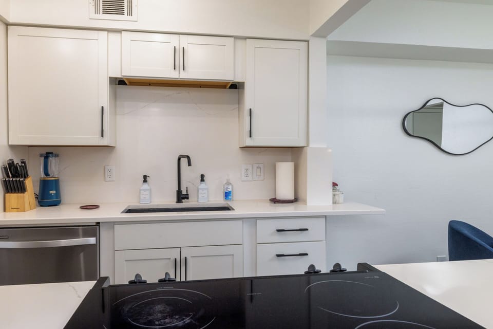 Modern kitchen w/ stainless steel appliances and stylish countertops & cabinetry