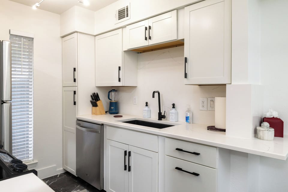 Modern kitchen w/ stainless steel appliances and stylish countertops & cabinetry