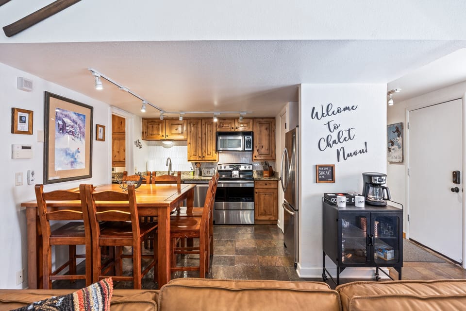 The open layout blends dining and cooking spaces seamlessly, with seating for six and natural light streaming through the living area. Perfect for family breakfasts or cozy evening dinners at home.