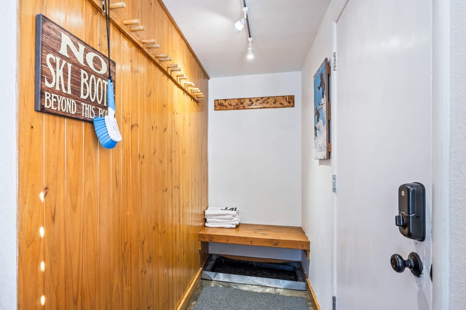 Conveniently designed mudroom and entryway with dedicated ski boot storage and bench seating. A practical space to gear up before hitting the slopes or to warm up after a day on the mountain.