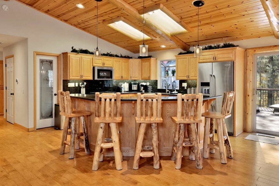 Fully equipped kitchen featuring generous counter space and bar seating—perfect for casual meals, morning coffee, or entertaining. A great central hub for gathering and conversation.