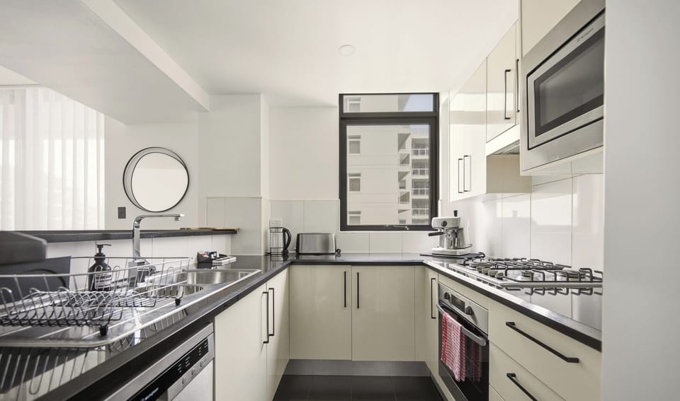 A clean, functional kitchen equipped with modern appliances and light-toned cabinetry.