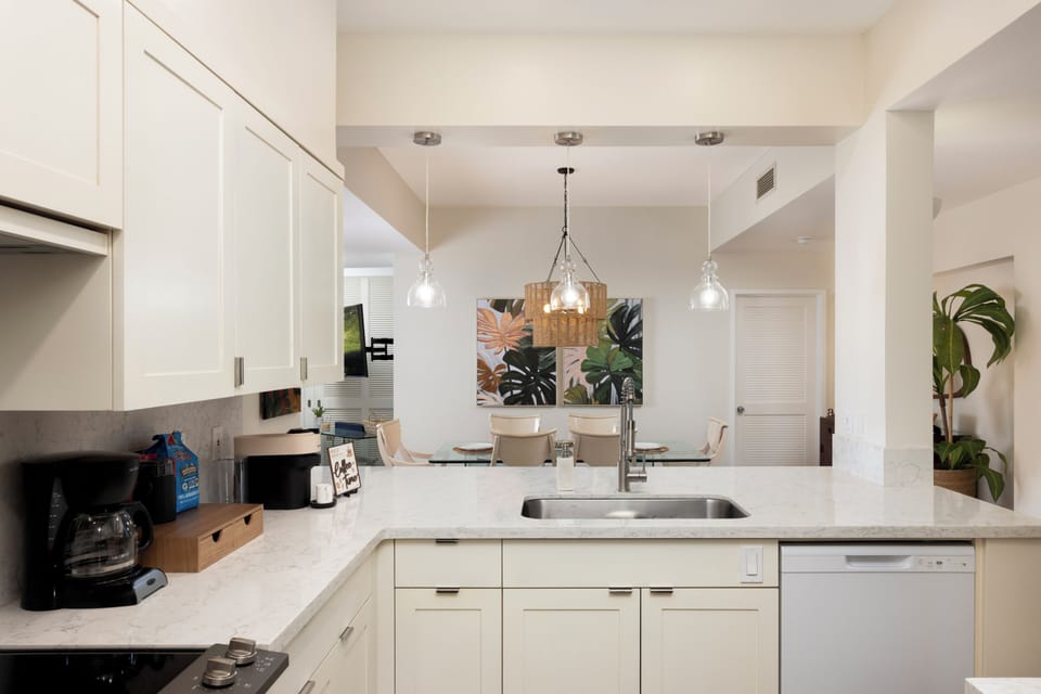 Fully stocked kitchen opening to the dining room for your cooking needs.