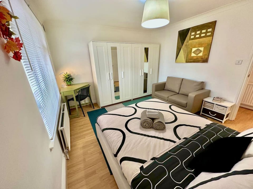 Second double bedroom with sofa and wardrobes