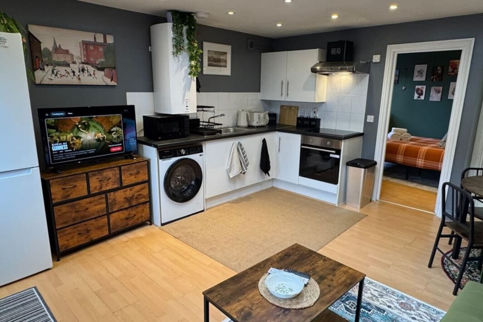 Full kitchen unit and TV in living area