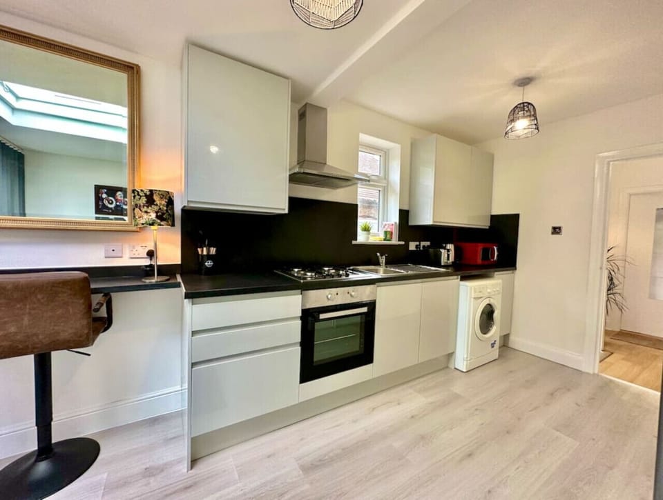 Sleek kitchen with modern appliances and breakfast bar