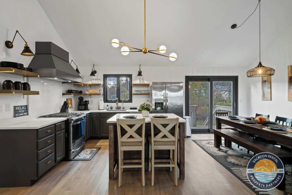 Modern, fully-stocked kitchen with stainless appliances, large island with bar seating, and everything you need to cook