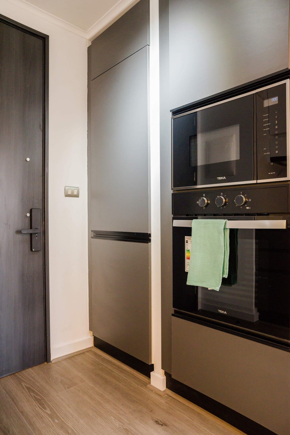 Modern kitchen with sleek appliances and ample storage, perfect for culinary adventures in your cozy studio.