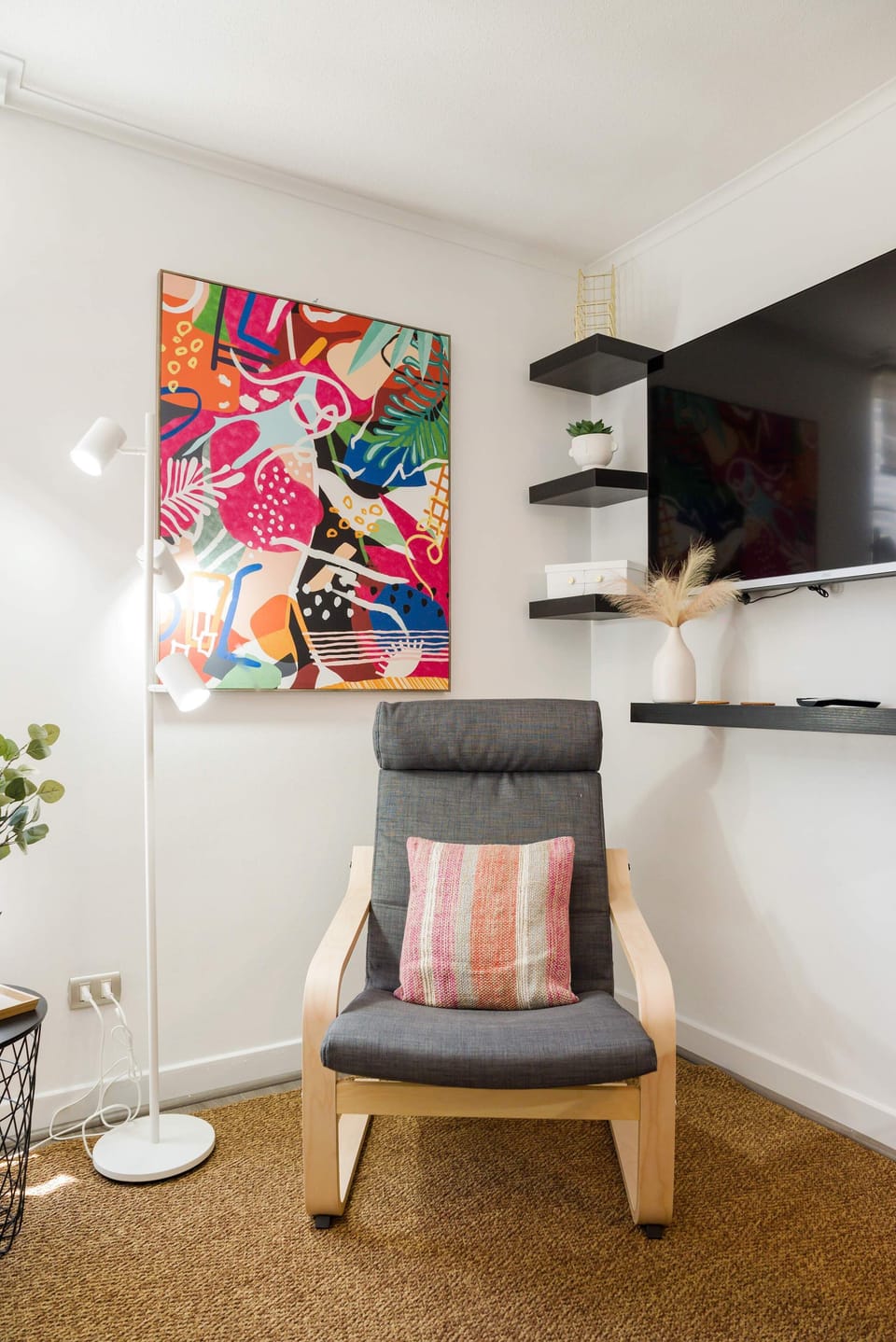 Relax in this stylish nook with vibrant art and modern comforts, perfect for unwinding after a day of exploring.