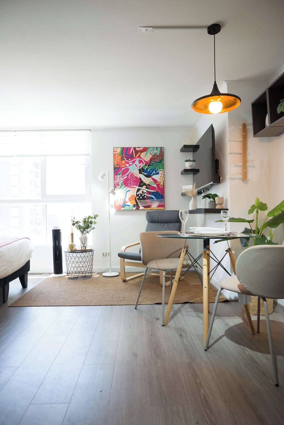 Cozy studio with vibrant decor and natural light, perfect for a relaxing stay in the heart of the city.