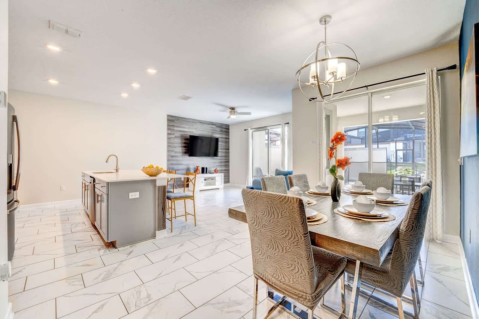Modern open-concept dining and kitchen area with natural light and stylish finishes.