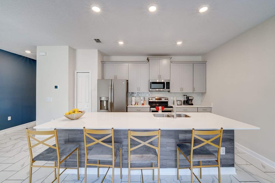 Modern kitchen with a large island and seating for four.