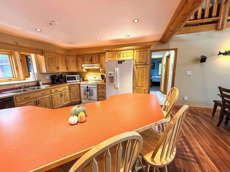 The kitchen island is large and has storage below with dishes. 