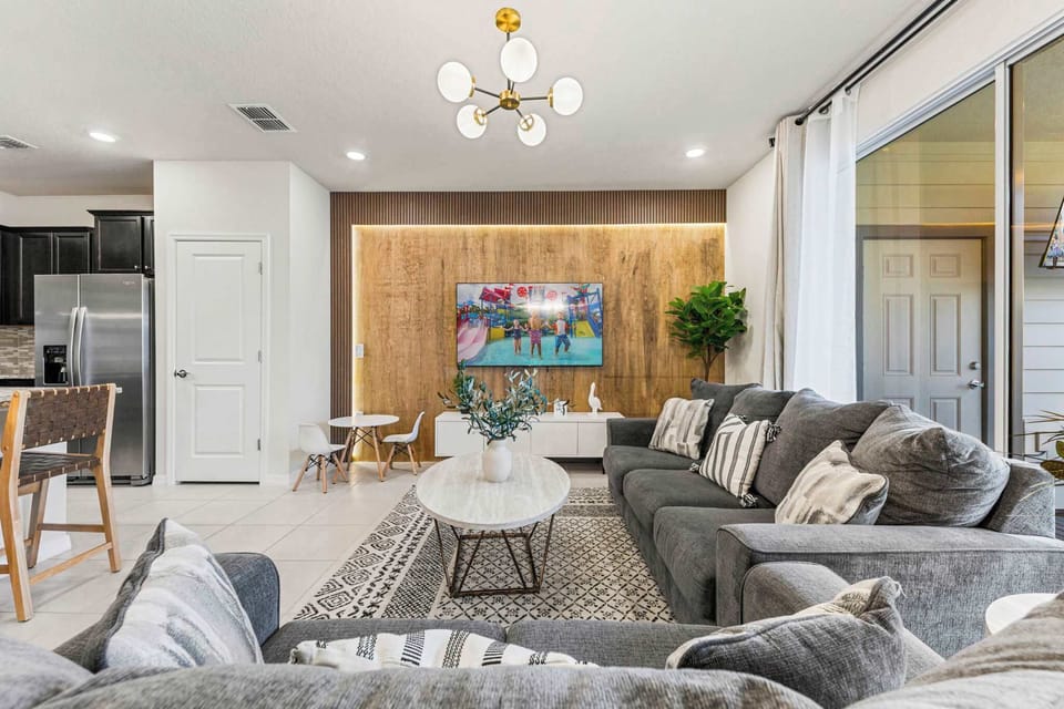 Relax in a bright, open space featuring elegant furniture and a warm, inviting ambiance.