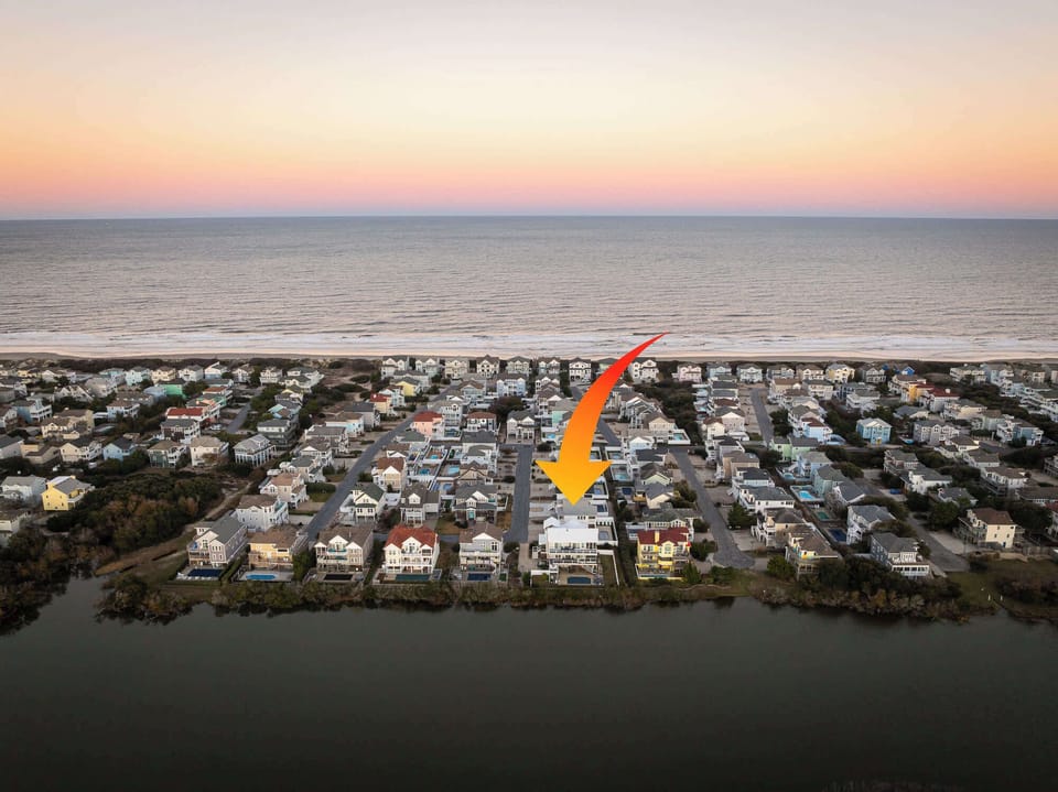Zoomed-out Aerial view of the home with nearby lake.