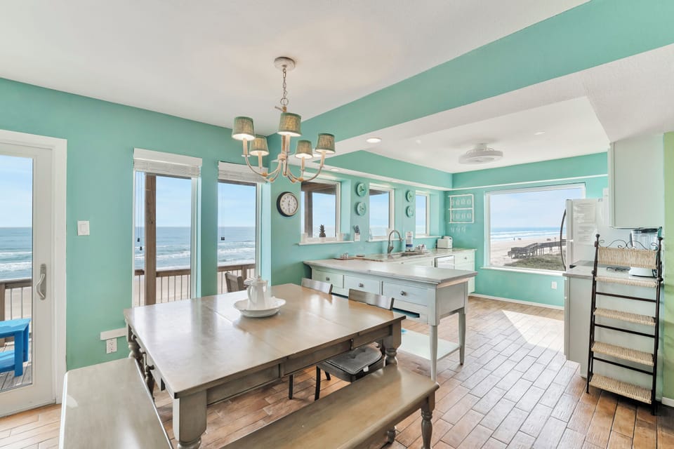 Soak in breathtaking ocean views from your bright, coastal-inspired kitchen and dining space with panoramic windows framing the endless sea.