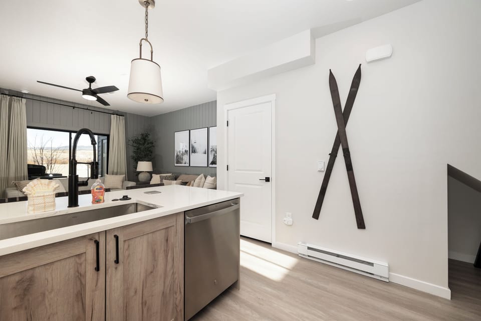Your modern kitchen opens to a bright living space with mountain views, perfect for cooking and relaxing together.