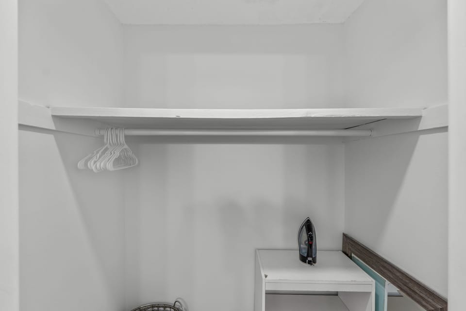 Your dedicated closet space features hanging storage and a convenient ironing station for keeping your wardrobe crisp.