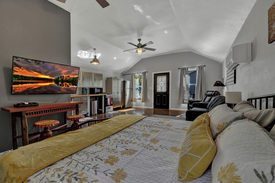Relax in Hill Country charm! This cozy cabin blends rustic vibes with Texas pride, surrounded by trees, firepit seating, and peaceful nature—perfect for a Fredericksburg getaway.