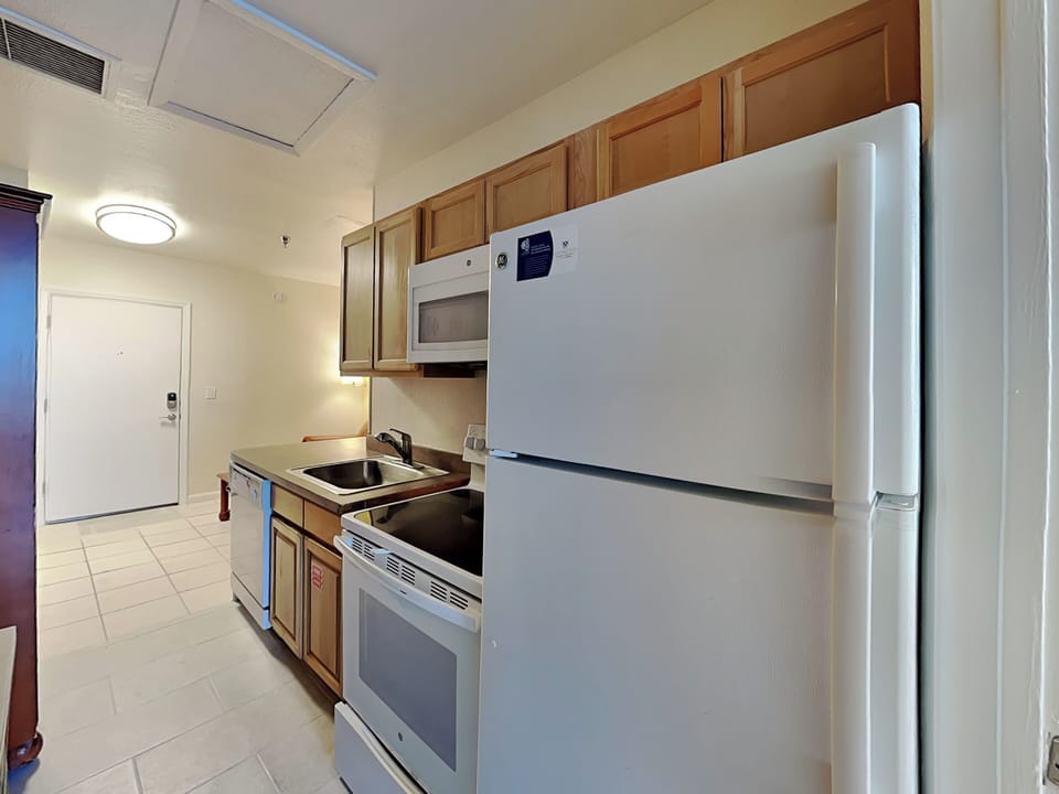 Your fully equipped kitchen awaits with everything you need to create memorable meals during your stay. The warm wood cabinets and modern appliances make cooking feel like home.