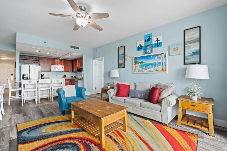 Relax in this coastal-themed living room with comfortable seating and vibrant decor.