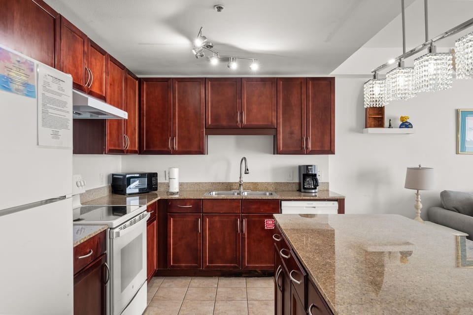 Modern kitchen with dark wood cabinets and granite countertops