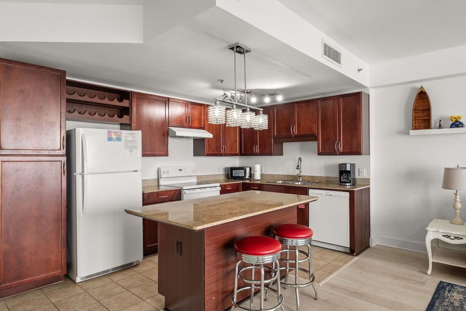 Modern kitchen with a central island and seating for two.