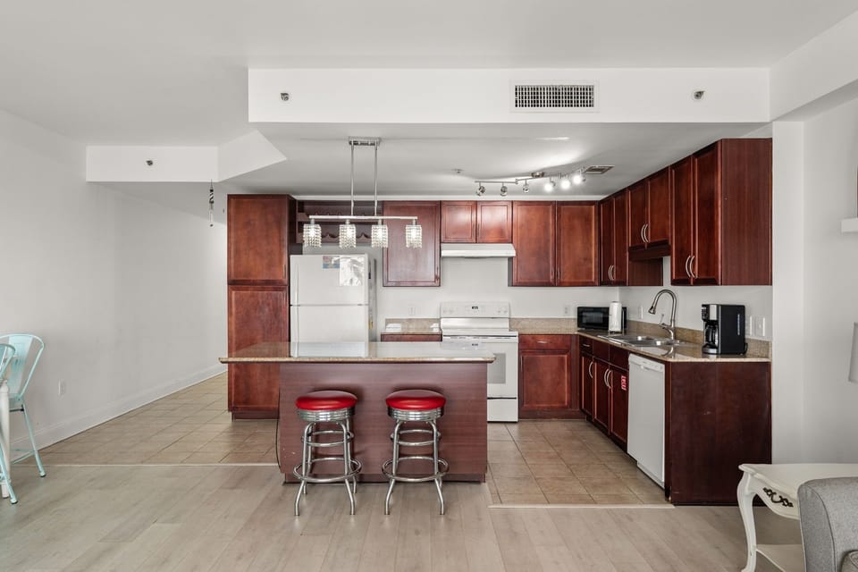 Modern kitchen with dark wood cabinets and a central island with seating