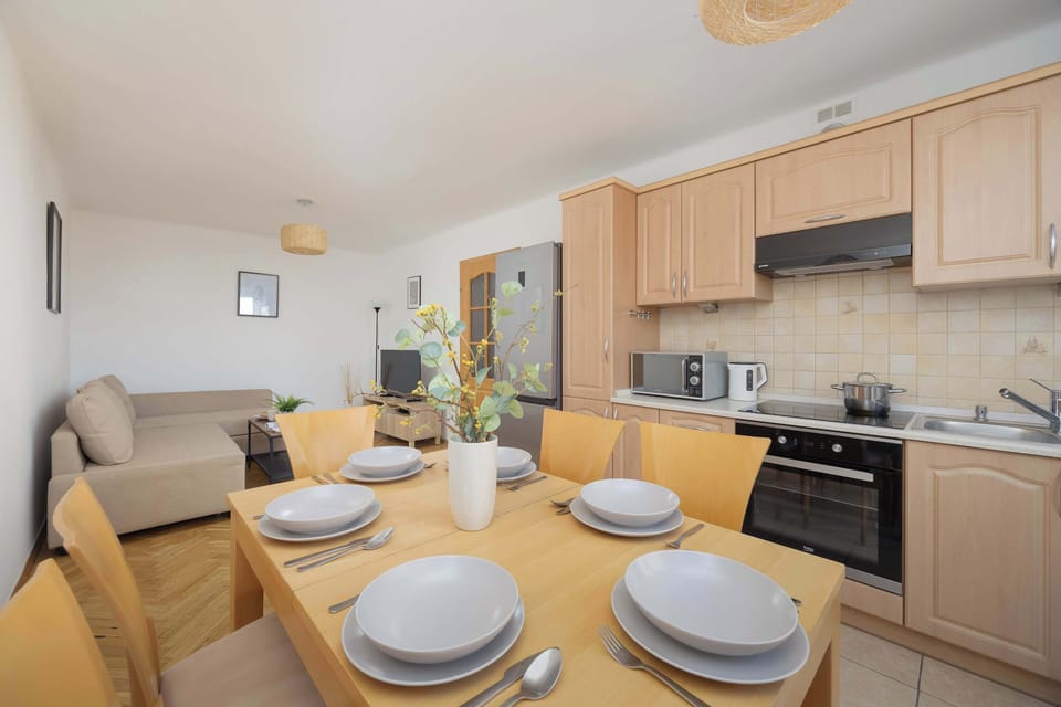 The open layout of the kitchen and living area encourages shared moments and convenient cooking.