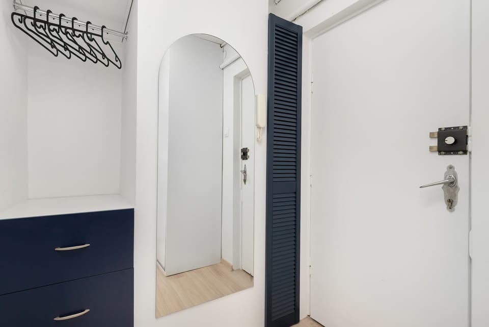 A bright hallway with a large mirror.