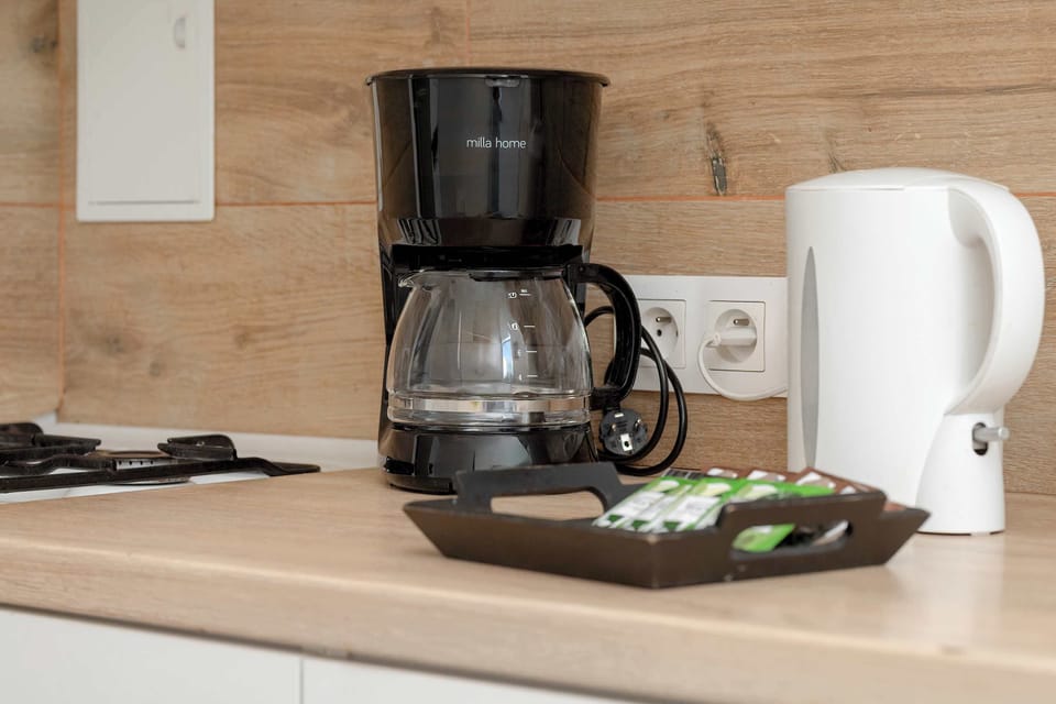 There is a filter coffee machine and an electric kettle on the countertop.