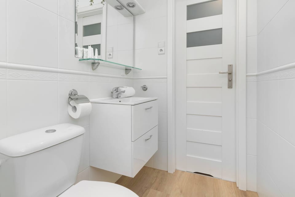 Minimalist white bathroom — clean, spacious, and comfortable.