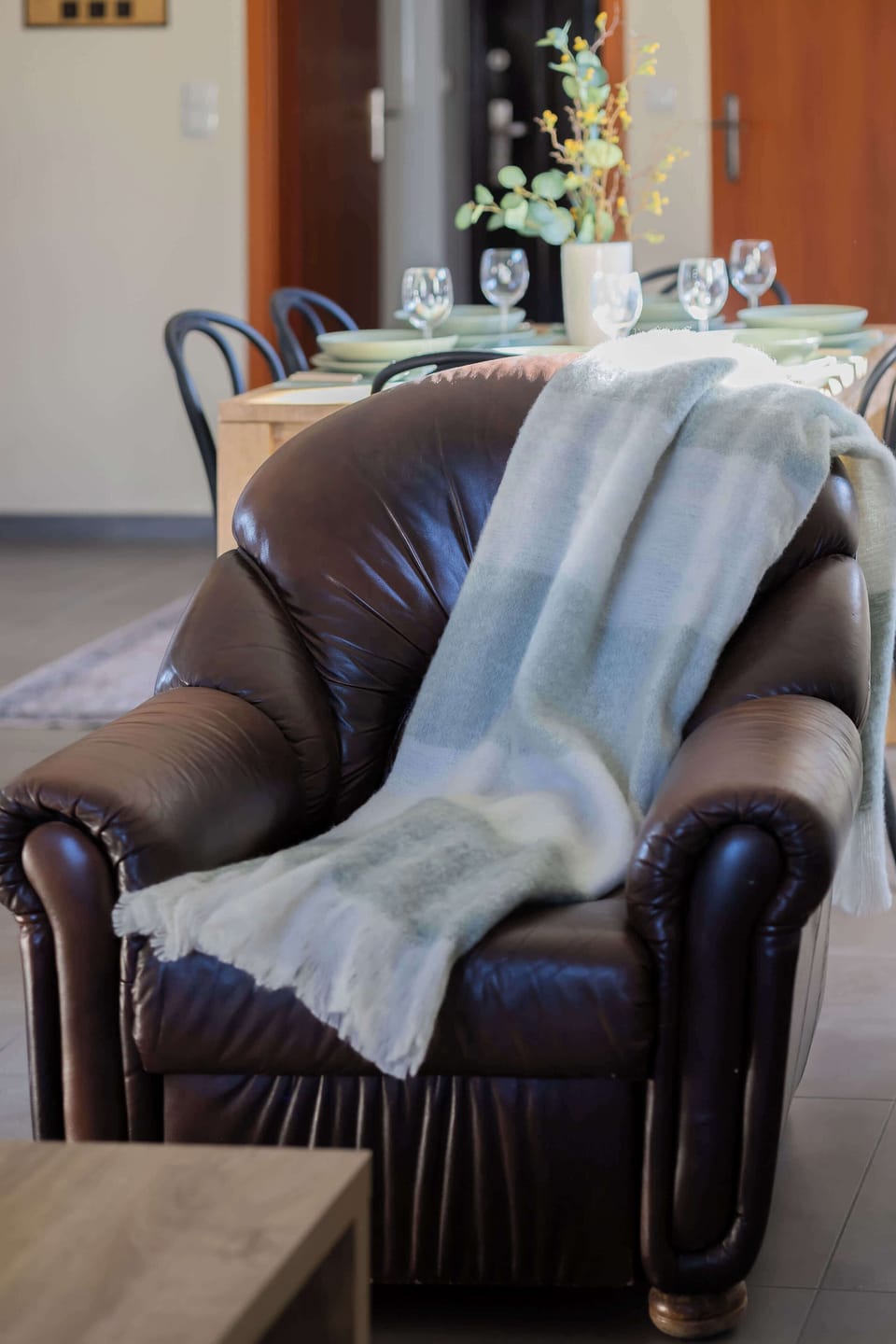 Stylish detail of the living area with rich textures and soft cushions.