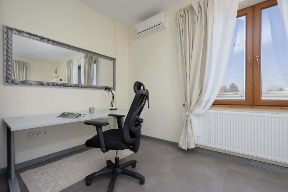 Dedicated workspace with a comfortable chair and natural light — perfect for productivity.