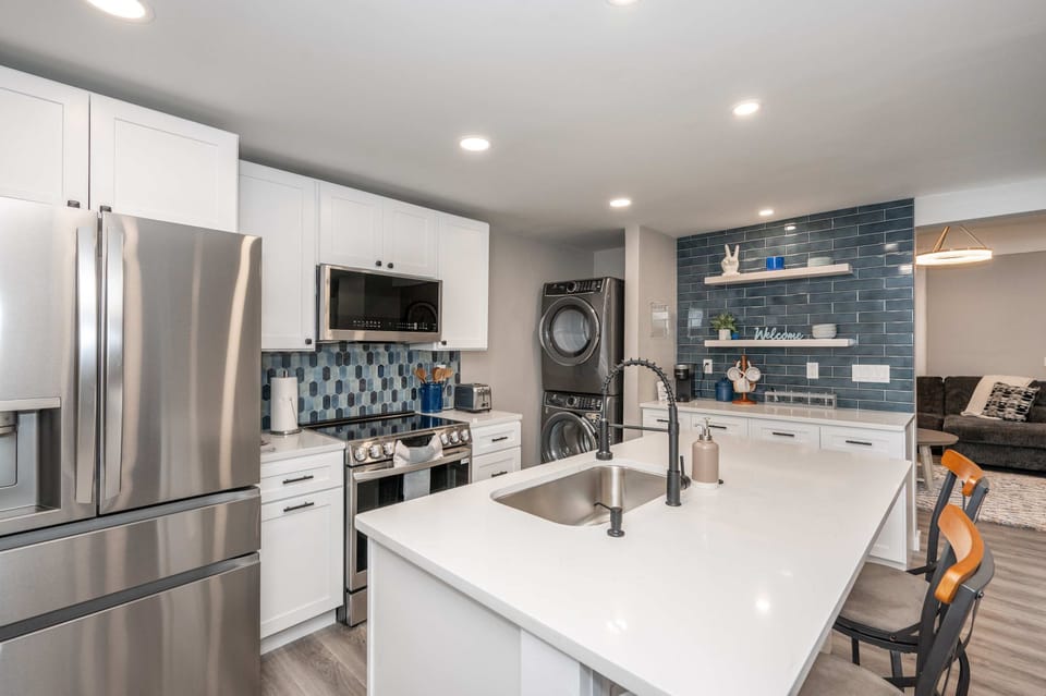 The chic, open kitchen offers ample space & all the comforts of home​