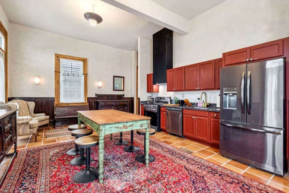 Fully equipped kitchen featuring modern appliances and eclectic décor.