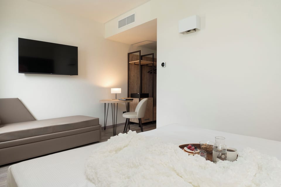 Superior Triple Room | Minibar, in-room safe, desk, laptop workspace