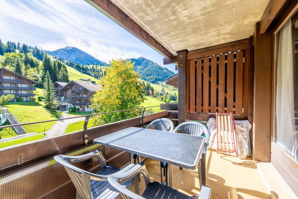 Sunny balcony with seating and beautiful alpine scenery